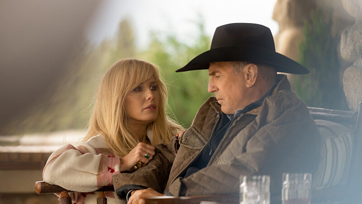 John and Beth Dutton speak closely on the ranch house's porch.