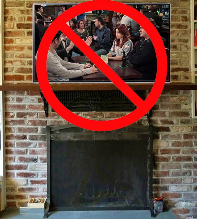 A well-used brick fireplace with a TV mounted above it. 