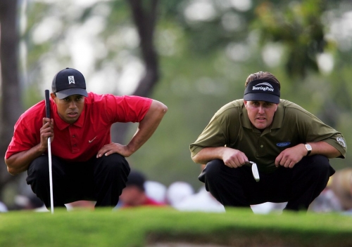 Woods and Phil Mickelson line up their putts during the final round of the Ford Championship in March 2005. For much of Woods' career, Mickelson was considered his biggest rival.