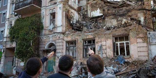 People look at the residential building destroyed by a Russian drone strike. At least four people have been killed as a result of a drone attack on a residential building in Kyiv, Ukraine on the morning of October 17, 2022. 