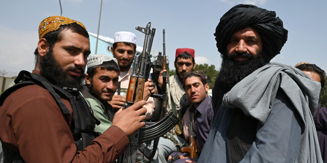 Taliban militants holding rifles. The Taliban has used Twitter for years and has praised Elon Musk since he purchased the platform. 
