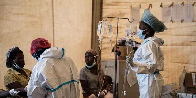 A woman carries her son, who has cholera, at Bwaila Hospital in Lilongwe central Malawi, on Jan. 11, 2023. Countries in Africa that have been affected by cholera outbreaks lack "immediate access" to vaccines.