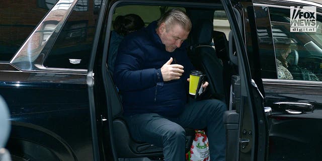 Alec Baldwin gets out of a car outside his apartment in Manhattan on Feb. 1. The actor was officially charged this week with involuntary manslaughter for the shooting death of Halyna Hutchins.