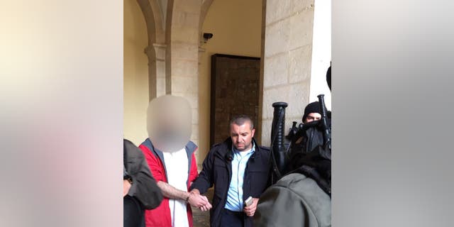 A photo from Israeli police arresting the suspect, a man in his 40s, after he broke a statue of Jesus Christ in the Church of the Flagellation.