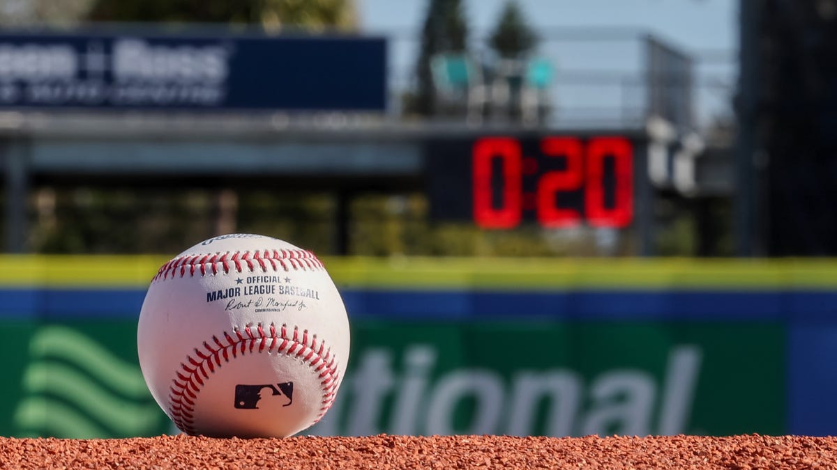 a baseball sits on a pitching mound while a pitch clock with 20 seconds on it is shown in the background