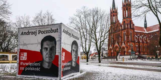 A banner with a picture of Belarusian-Polish journalist Andrzej Poczobut is seen in the center of Bialystok, Poland, on Jan. 21, 2023. Poczobut was sentenced to eight years in prison for "inciting discord" and harming the country's national security.