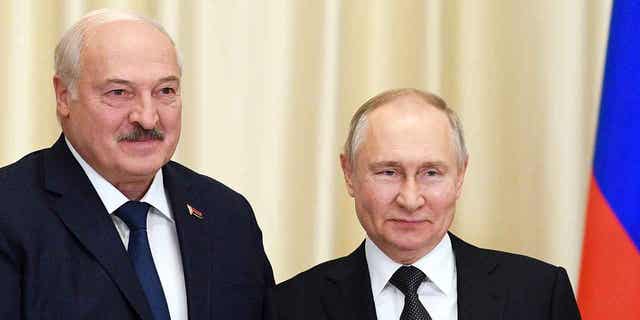 Russian President Vladimir Putin, right, and Belarusian President Alexander Lukashenko pose for a photo outside Moscow, Russia, on Feb. 17, 2023. Lukashenko is heading to Beijing to begin a three-day visit on Feb. 28, 2023.