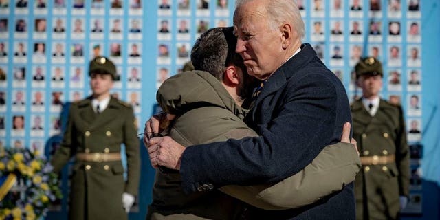 President Joe Biden and President Volodymyr Zelenskyy hug goodbye at the Memorial Wall of Fallen Defenders of Ukraine in Kyiv on Monday, Feb. 20, 2023.