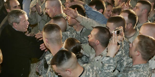 President George W. Bush greets troops during a surprise stopover at Bagram Air Base, Afghanistan, March 1, 2006. Bush made the stop on his way to visit India and Pakistan.