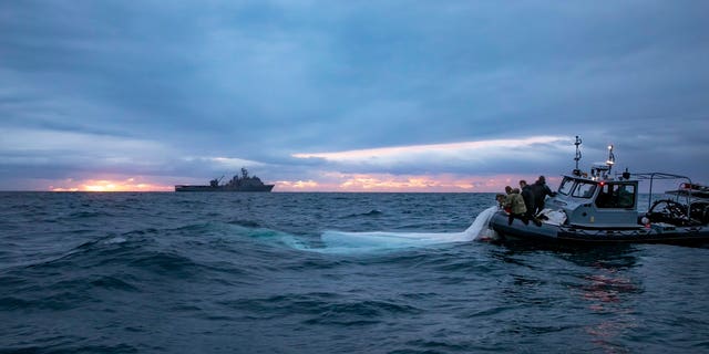 U.S. forces pull pieces of China's surveillance balloon out of the ocean.