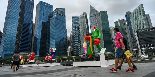 People walk along the promenade at Marina bay in Singapore on Feb. 1, 2023.