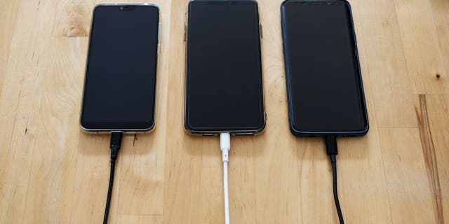 Three phones plugged in.