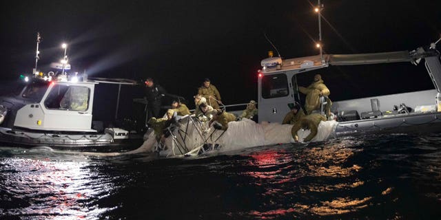 Sailors assigned to Explosive Ordnance Disposal Group 2 recover a high-altitude surveillance balloon off the coast of Myrtle Beach, South Carolina, Feb. 5, 2023.