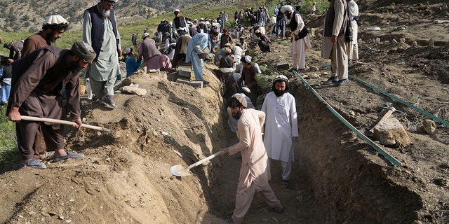 Afghans dig a trench for a common grave for their relatives killed in an earthquake to a burial site in Gayan village, in Paktika province, Afghanistan, Thursday, June 23, 2022. A powerful earthquake struck a rugged, mountainous region of eastern Afghanistan early Wednesday, flattening stone and mud-brick homes in the country's deadliest quake in two decades, the state-run news agency reported.