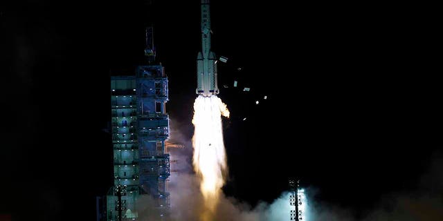 The crewed spaceship Shenzhou-13, atop a Long March-2F carrier rocket, is launched from the Jiuquan Satellite Launch Center in northwest China's Gobi Desert Oct. 16, 2021.