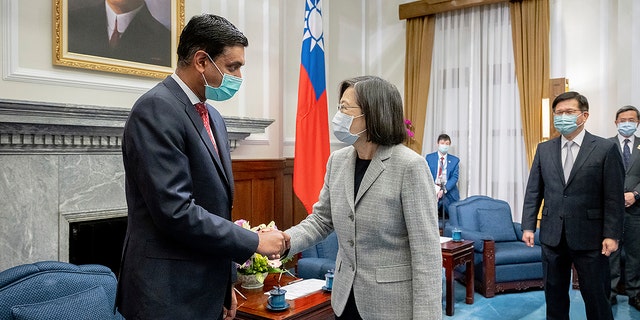 In this photo released by the Taiwan Presidential Office, Taiwan's President Tsai Ing-wen, center, shakes hands with California Rep. Ro Khanna during a meeting at the Presidential Office in Taipei, Taiwan on Tuesday, Feb. 21, 2023. 