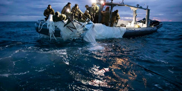 Sailors assigned to Explosive Ordnance Disposal Group 2 recover a high-altitude surveillance balloon off the coast of Myrtle Beach, South Carolina, Feb. 5, 2023.