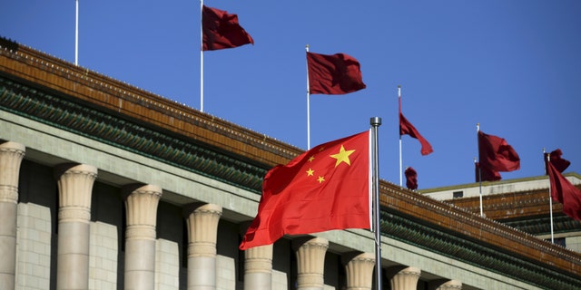 The Chinese flag waves in front of the Great Hall of the People in Beijing, China, Oct. 29, 2015.