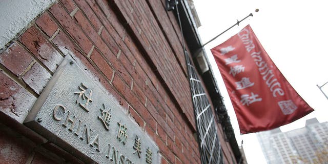 A plaque and a flag hang outside the China Institute, home of the Confucius Institute, in New York.
