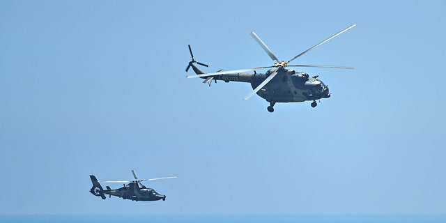 FILE PHOTO: Chinese military helicopters fly past Pingtan island, one of mainland China's closest point from Taiwan, in Fujian province.