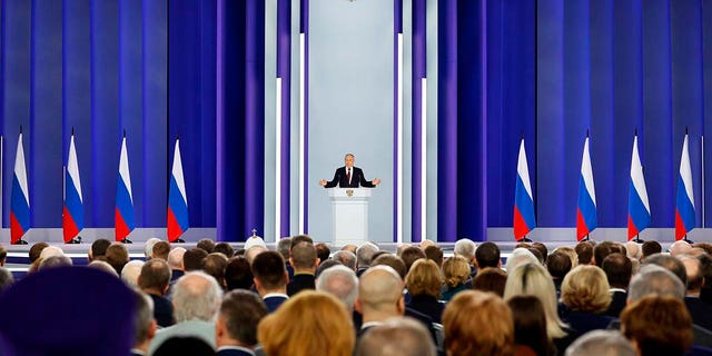 Russian President Vladimir Putin gestures as he gives his annual state of the nation address in Moscow, Russia, Tuesday, Feb. 21, 2023. The Russian president has threatened to resume nuclear weapons testing if the US makes the first move.