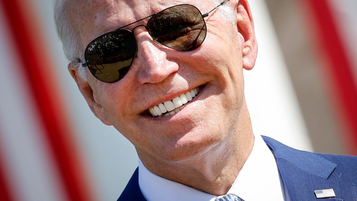 Joe Biden smiling and wearing aviator sunglasses