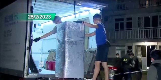 Police loads the refrigerator that is suspected of having been used to keep body parts of 28-year-old model Abby Choi, onto a truck in Hong Kong Feb. 25, 2023 in this screen grab taken from a handout video. 