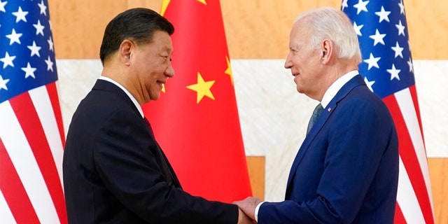 U.S. President Joe Biden, right, and Chinese President Xi Jinping shake hands before their meeting on the sidelines of the G20 summit meeting.