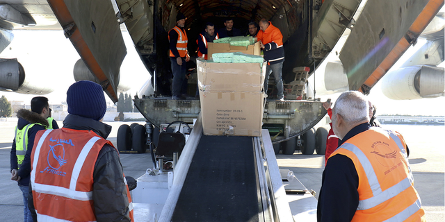 Workers unload humanitarian aid sent from Armenia, for Syria following a devastating earthquake, at the airport in Aleppo, Syria, on Thursday, Feb. 9.
