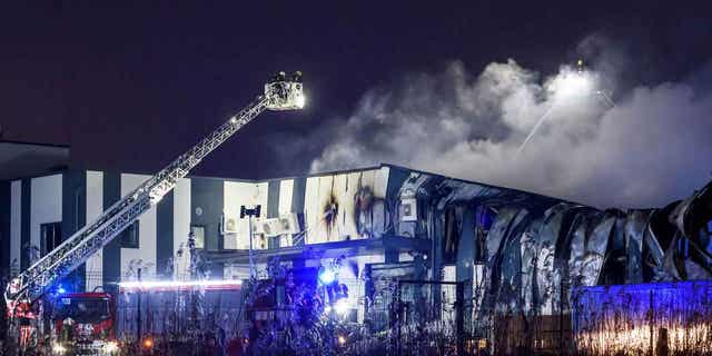 Firefighters extinguish a fire at a drone factory in Marupe, Latvia, on Feb. 7, 2023. 