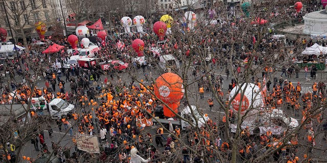 Protesters gather before a demonstration against a pension reform aimed at raising the minimum retirement age from 62 to 64, on Feb. 16, 2023, in Paris, France.
