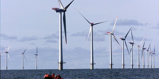 A boat passes along offshore windmills set up in the North Sea near Esbjerg, Denmark, on Oct. 30, 2002. Germany wants to create a web of power lines to connect the country’s offshore wind parks with those of its North Sea neighbors.