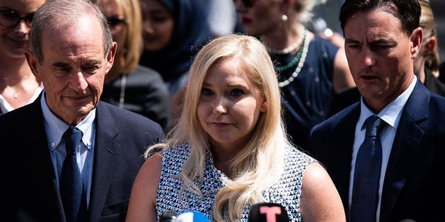 Virginia Giuffre, an alleged victim of Jeffrey Epstein, center, pauses while speaking with members of the media outside federal court in New York, on Tuesday, Aug. 27, 2019. 