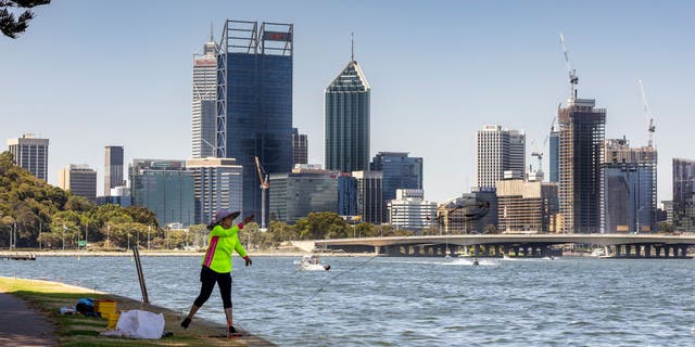 A lady throws a crab net out from the banks of the Swan River on January 22, 2022 in Perth, Australia. 