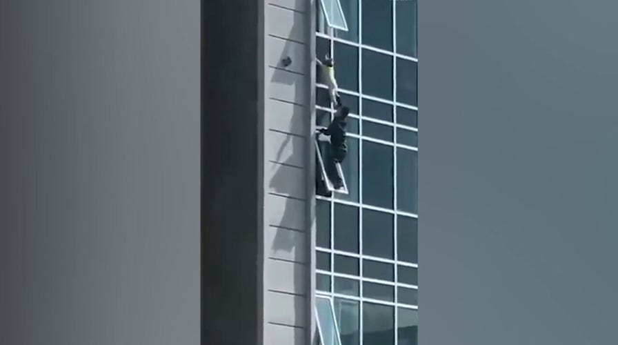 Heroic man saves boy hanging from a window in China