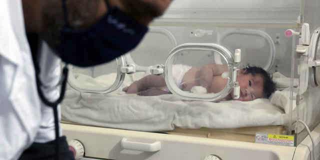 A baby girl, who was born under earthquake rubble in Syria, receives treatment inside an incubator at a children's hospital in the town of Afrin, Syria, on Feb. 7, 2023.