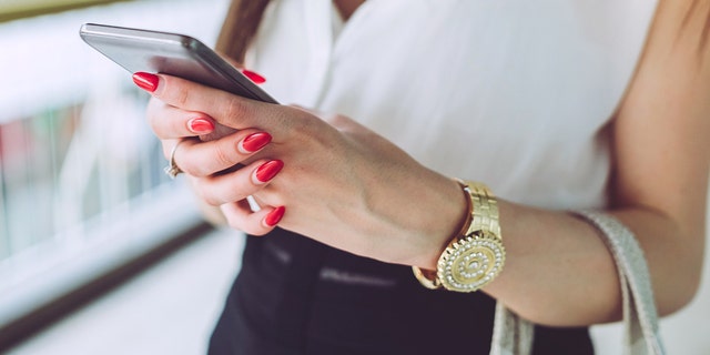 Woman texting on phone istock