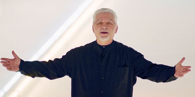 Fashion designer Paco Rabanne acknowledges the applause at the end of his fall-winter collection on March 3, 2000, in Paris, France.