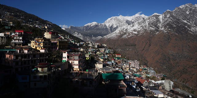 The town of Joshimath, India, is seen alongside snow-capped mountains on Jan. 21, 2023. For months, residents in Joshimath have seen their homes slowly sink. 