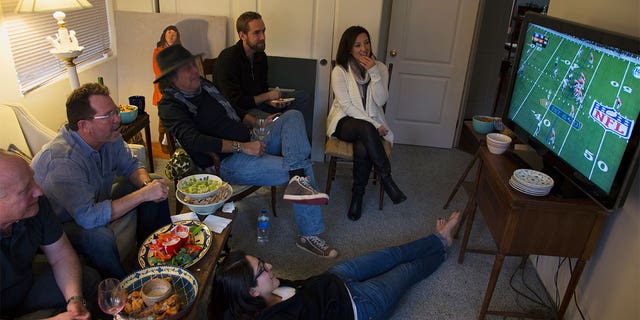 Group of people watch NFL Super bowl XLVIII on television, Feb. 2, Denver Broncos vs Seattle Seahawks. (Photo by: Joe Sohm/Visions of America/Universal Images Group via Getty Images)