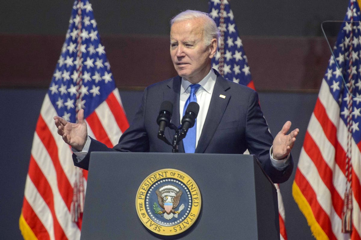 President Joe Biden standing at a podium, gesturing broadly
