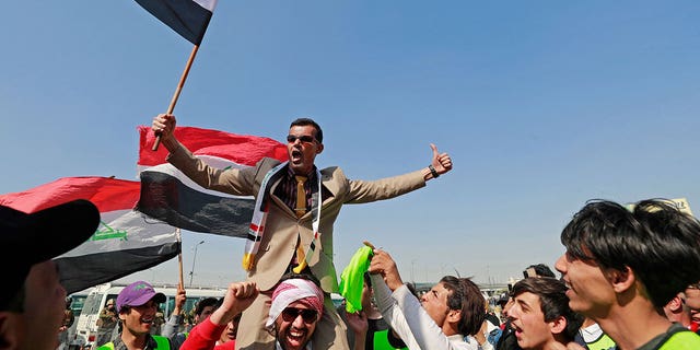 People protest in Baghdad on Feb. 27, 2023, against the Parliament's attempt to amend an electoral law.