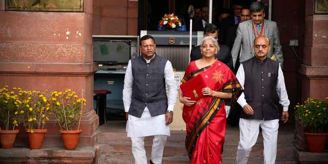 Indian Finance Minister Nirmala Sitharaman, center, leaves her office to give a speech in New Delhi, India, on Feb. 1, 2023.