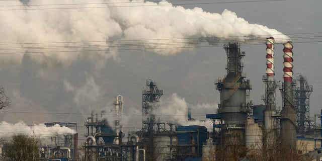 Smoke and steam rise from a coal processing plant in Hejin in central China's Shanxi Province on Nov. 28, 2019. The International Energy Agency on Feb. 21, 2023, accused fossil fuel industries of not doing enough to curb methane emissions.