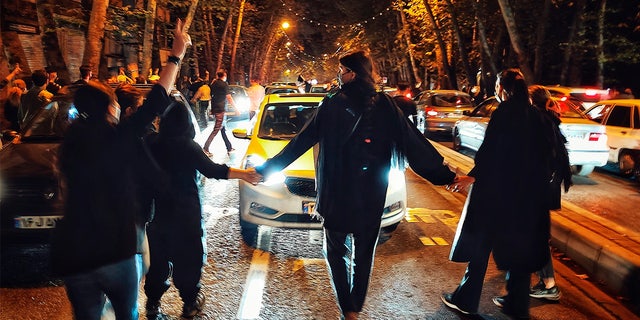 Women protest the death of 22-year-old woman Mahsa Amini who was detained by the morality police, in Tehran, Saturday, Oct. 1, 2022.