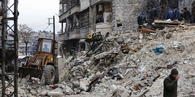 Syrians search for victims and survivors at the rubble of a collapsed building following a deadly earthquake on Feb. 6, 2023. Syria's long-time enemy neighbor Israel said it will send relief.