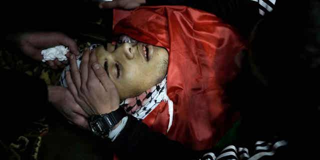 The body of Hamza al-Ashqar, 17, is shown after he was shot by Israeli troops on Feb. 7, 2023. The Israeli military said its troops came under attack during a raid in Nablus, where soldiers fired at an armed Palestinian who shot at them. 