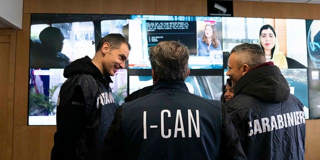 Italian carabinieri and police officers tasked against the 'ndrangheta talk at the Interpol headquarters in Lyon, France, on Feb.2, 2023.