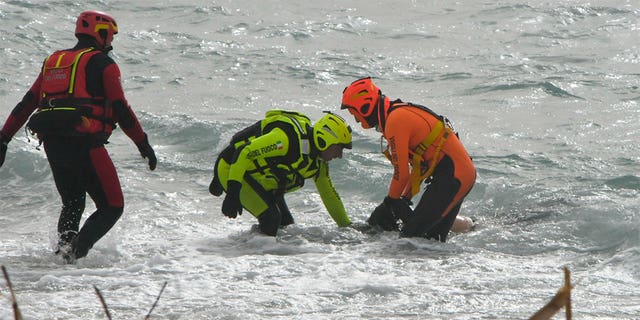 Crews recover a body near Cutro, southern Italy, Sunday, Feb. 26, 2023. 