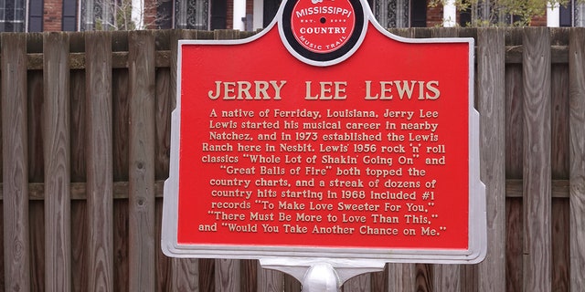 A sign outside the Mississippi home of entertainer Jerry Lee Lewis pays homage to the late musician.